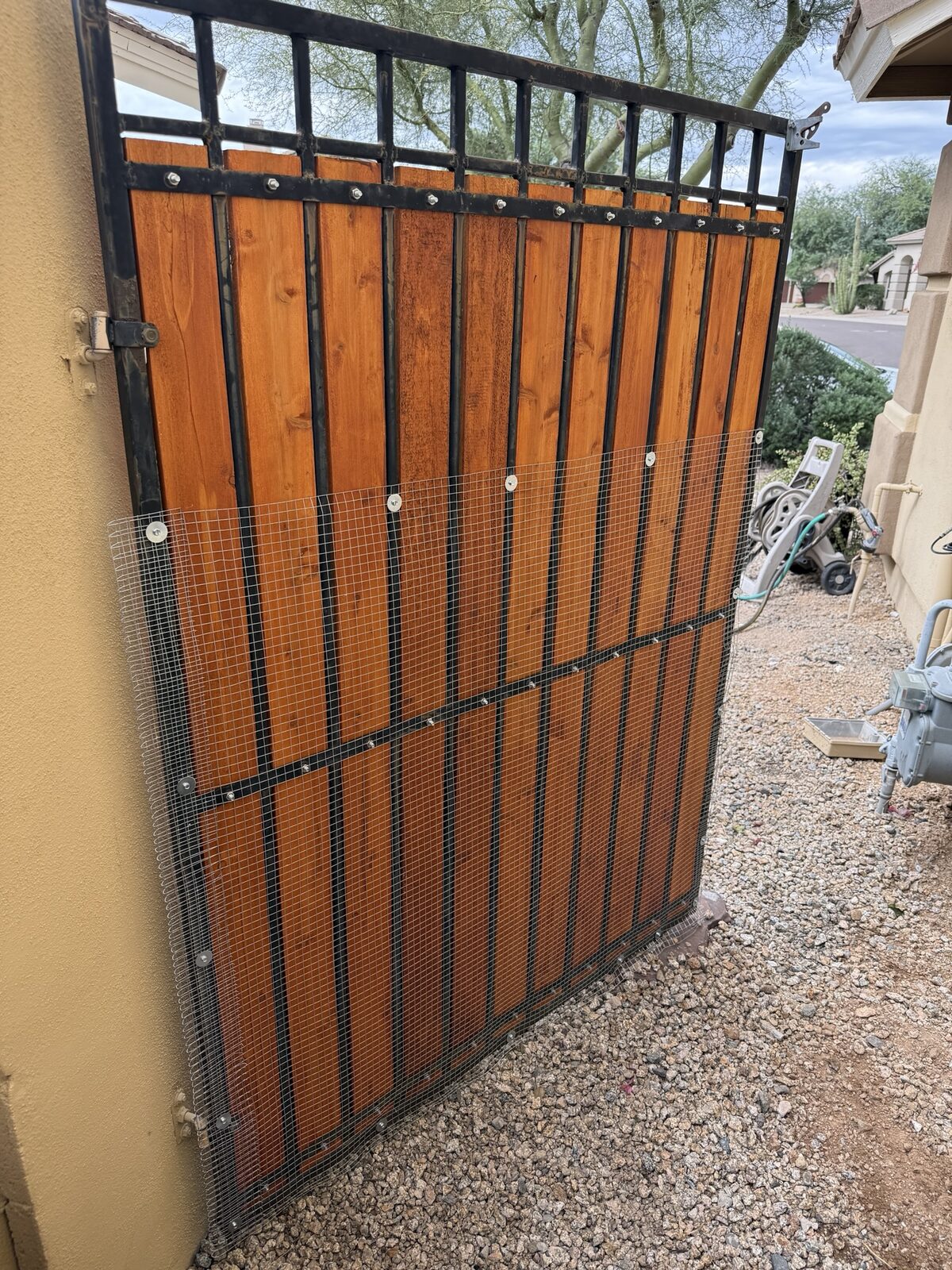 After: gate wrapped with 4-foot snake mesh from the ground up